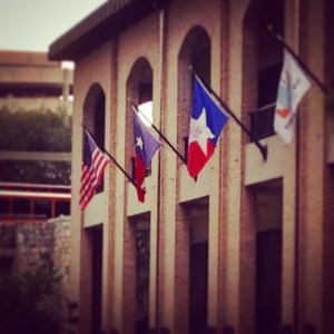 Flags adorn a building in San Antonio.